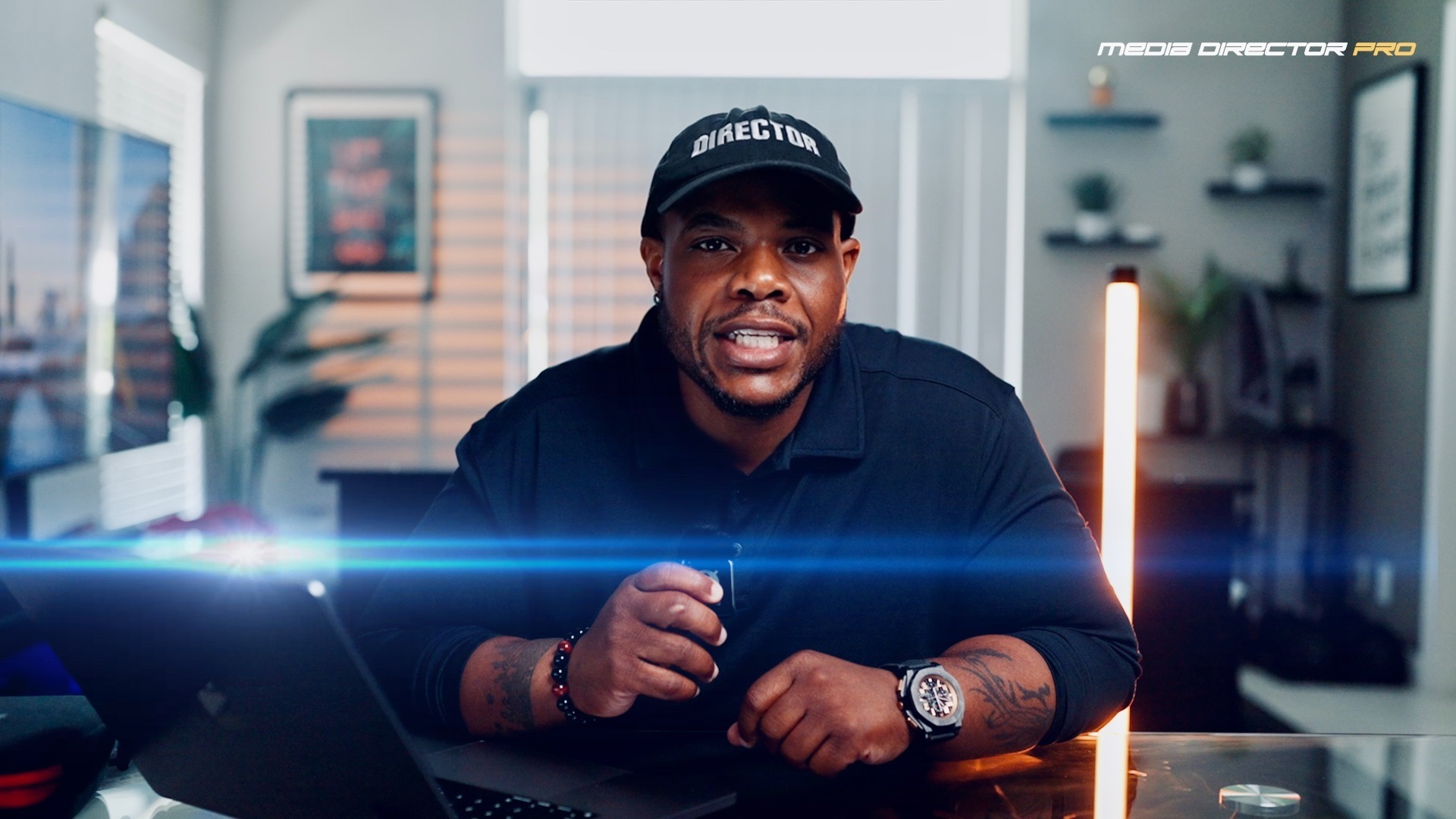 Reginald, founder of Media Director Pro, at his desk in a DIRECTOR cap